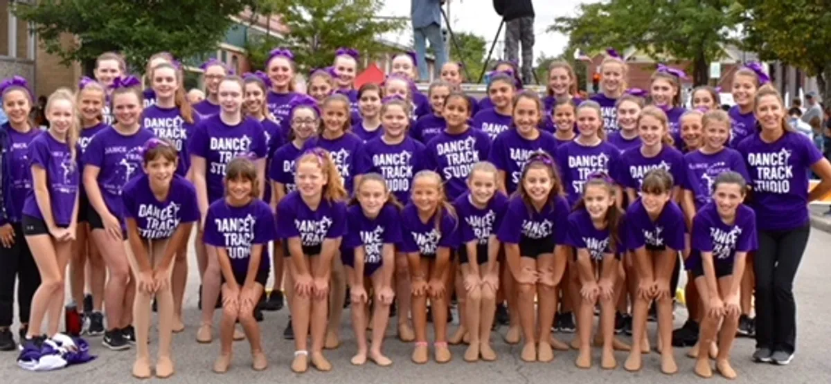 A group of girls in purple shirts and shorts.